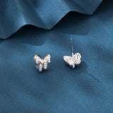 925 Sterling Silver Elegant Butterfly Stud Earrings With Silver Zircon Accents On Blue Backdrop