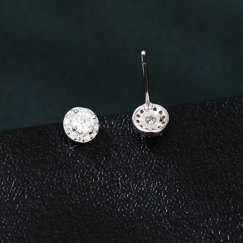 925 Sterling Silver Elegant Moissanite Halo Stud Earrings On Black Wood With Teal Background